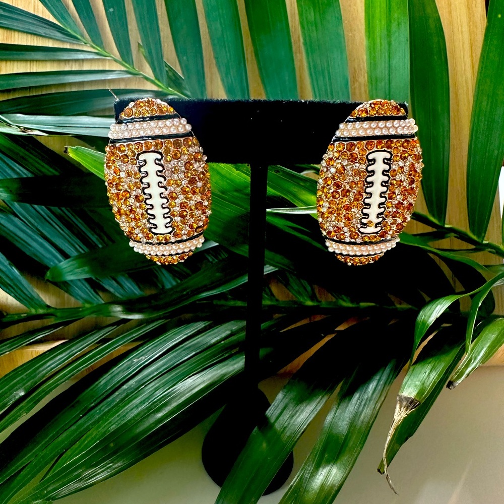 Football earrings rhinestones brand new in box.